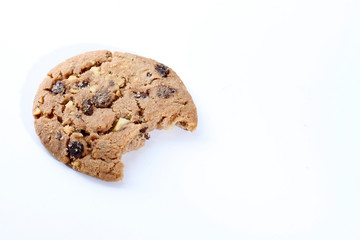 Chocolate chips and hazelnuts over white background