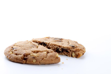 Chocolate chips and hazelnuts over white background