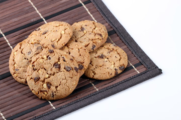 Chocolate chips and hazelnuts over white background