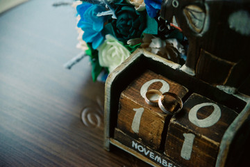 gold wedding rings on a calendar with the number 11