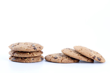 Chocolate chips and hazelnuts over white background