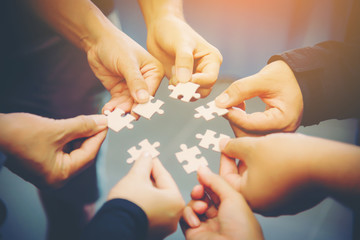Close-up Photo Of Businesspeople Holding Jigsaw Puzzle