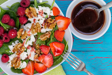 Tasty fresh salad with baby spinach and walnuts