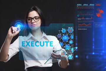 The concept of business, technology, the Internet and the network. A young entrepreneur working on a virtual screen of the future and sees the inscription: Execute