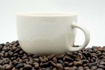 white coffee cup and coffee beans  isolated on white background .