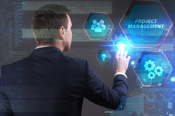 Business, Technology, Internet and network concept. Young businessman working on a virtual screen of the future and sees the inscription: Project management