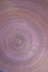 Abstract detail of a bronze base made up of concentric circles and drawn inside each other.