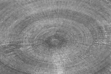 Abstract detail in black and white of a bronze base made up of concentric circles and drawn inside each other.