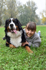Naklejka na ściany i meble little girl play with dog in the park