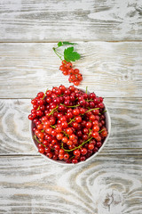 Red currant on white shabby wooden background. Top view, space for text.