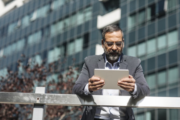 Businessman Reading Outdoors