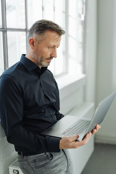 Businessman using a handheld laptop computer