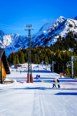 Fototapeta premium Familiy winter sport in Bellevue Les Houches Saint-Gervais, France. Top of Alps mountain near Mont Blanc. Perfect snow depths for winter sport, ski. Famous touristic area with beautiful landscape. 