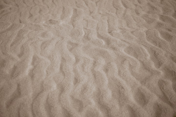 beige background with sand in the shape of sand waves
