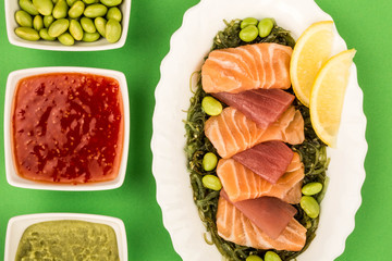 Japanese Style Slices Of Salmon and Tuna Sashimi On A Bed Of PIckled Seaweed