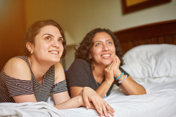 Two girl friends on bed