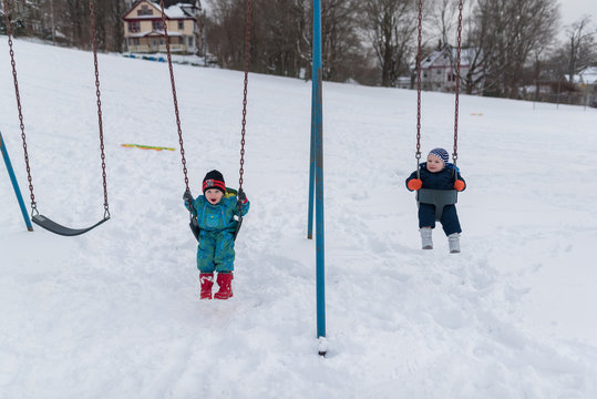 Toddlers Swining In The Snow