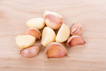 Garlic isolated on wooden background