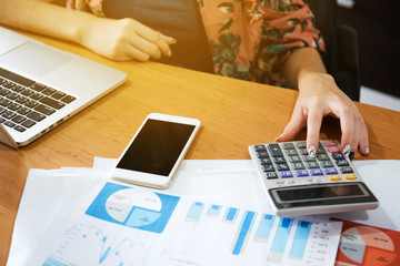 Woman calculate the cost in her work  in the office.