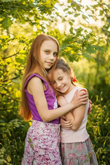 Fototapeta premium Two children girls sisters in the summer garden.