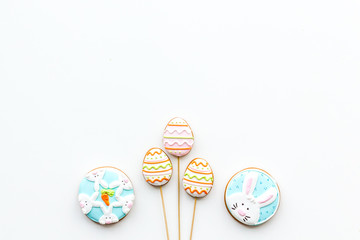 Fototapeta na wymiar Sweets, pastry for Easter table. Easter eggs and Easter bunny concept. White background top view copy space