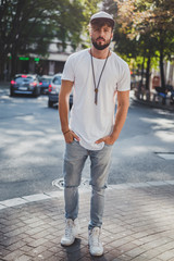 Obraz premium Serious man standing on the sidewalk and looking straight ahead