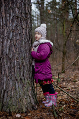 Little cute girl posing in autumn forest