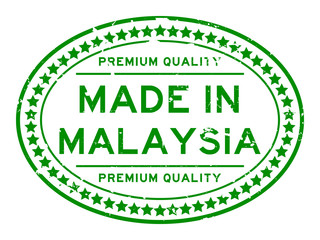 Grunge green premiumq quality made in Malaysia oval rubber seal business stamp on white background