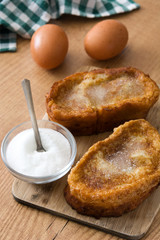 Traditional homemade Spanish torrijas on wooden background. Easter dessert.