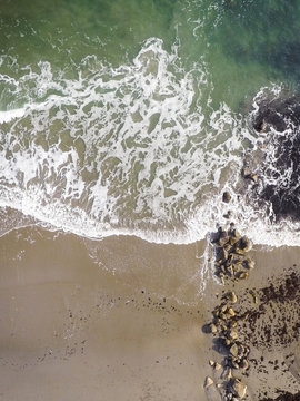 High Angle Scenic View Of Waves On Shore At Beach