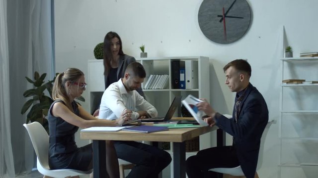 Frustrated female team leader scolding ineffective employees for bad work results and complaining on target sales failure. Angry businesswoman yelling at workers for missing deadline in office