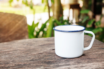Vintage coffee cup on old wooden table.