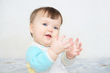 clapping hands cute smiling baby, caucasian blue eyes cheerful infant playing funny