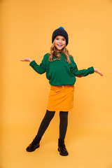 Fototapeta na wymiar Full length image of Happy girl in sweater and hat