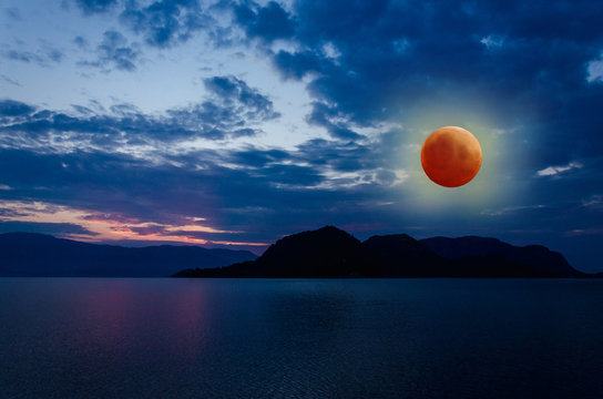 Super Blue Blood Moon Eclipse Lunar Color Sky on background of ocean and mountains nature in beach