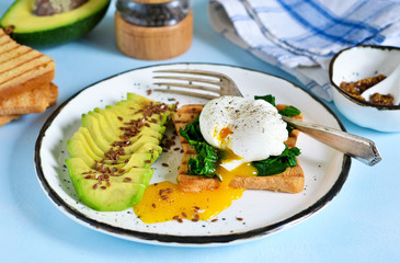 Quick breakfast - poached egg with toast, spinach and avocado.