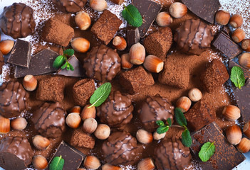 Chocolate shonfet with praline, truffles, chocolate, cocoa. Chocolate photo background.