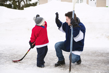 Father and son playing hockey