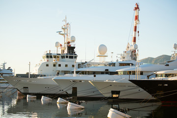 Luxury yachts moored to the pier in the marina