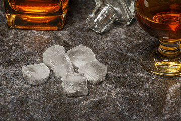 A glass of cognac or whiskey on the background of marble.
