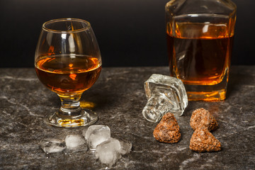 A glass of cognac or whiskey on the background of marble.

