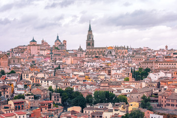 Fototapeta premium Old city of Toledo with Primate Cathedral of Saint Mary, churches of San Ildelfonso, San Roman and Santo Tome at sunset, Castilla La Mancha, Spain.