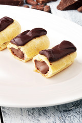 Traditional French dessert. Eclair with chocolate icing. Pastery concept