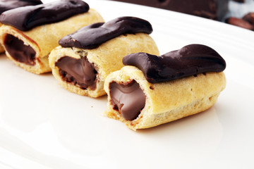 Traditional French dessert. Eclair with chocolate icing. Pastery concept