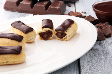 Traditional French dessert. Eclair with chocolate icing. Pastery concept
