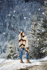 Happy young woman walking in winter time. Happy girl having fun in the snow. Snow covered trees in the winter sun light. Snowy pine trees on a winter landscape. snovy trees on winter mountains