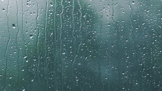 real rain drops sliding on window glass