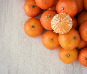 Fresh mandarins and peeled mandarins