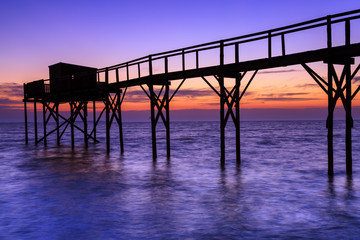 Fototapeta premium Beautiful view of fishing huts at sunset over the Atlantic Ocean