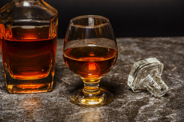 A glass of cognac or whiskey on the background of marble.
